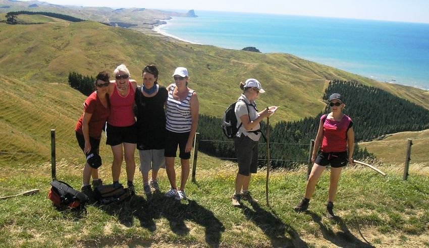 Walkers pausing above the Wairarapa coast