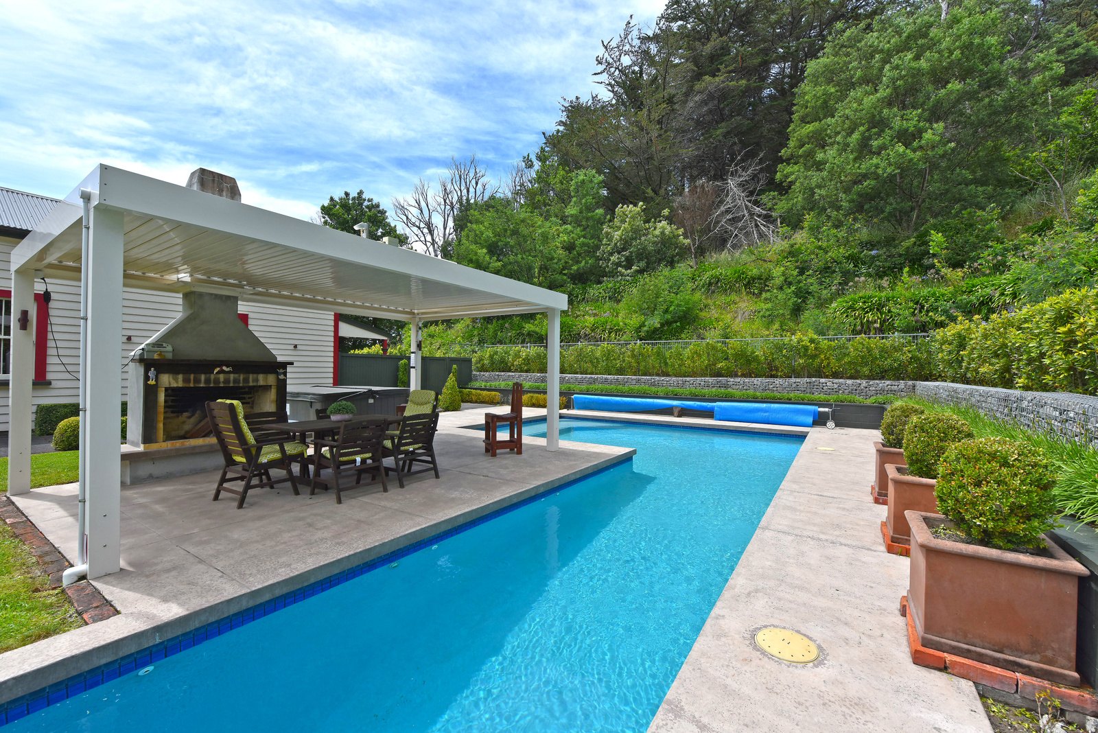Outdoor swimming pool and heated spa area at Ica Station